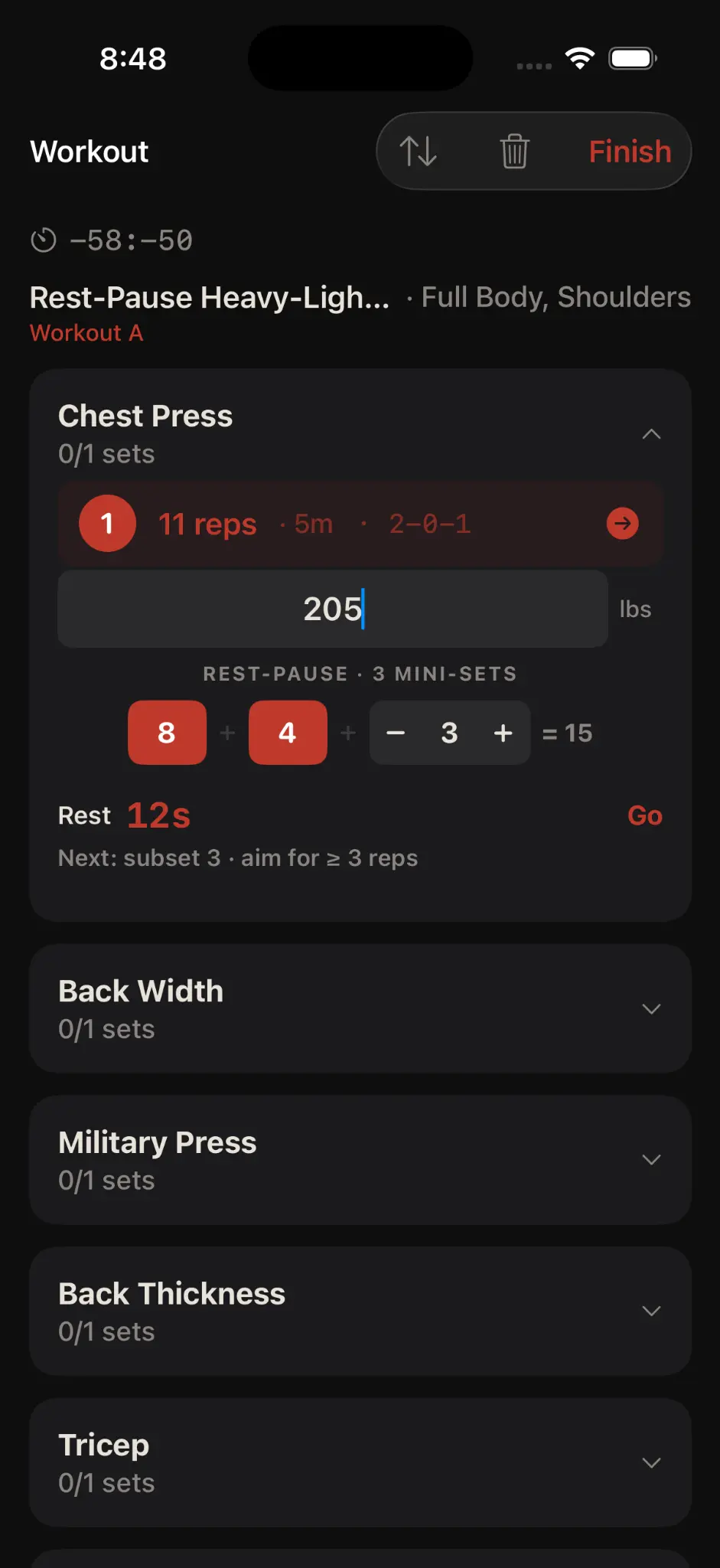 Korivo workout logging screen showing a chest press rest-pause set and structured mini-sets.